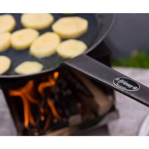 Durable wrought iron pan with a long handle cooking sliced potatoes over an open flame on a portable stove, ideal for Farm, Garden & Tool, Kitchen & Food, Camping, Cookware, Pots and Pans, Best Sellers, and Promo Eligible collections.