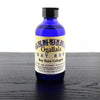 Blue glass bottle of handcrafted cologne made in USA with black cap and beige label featuring vintage-style text, part of Health & Wellness and Grooming collections.