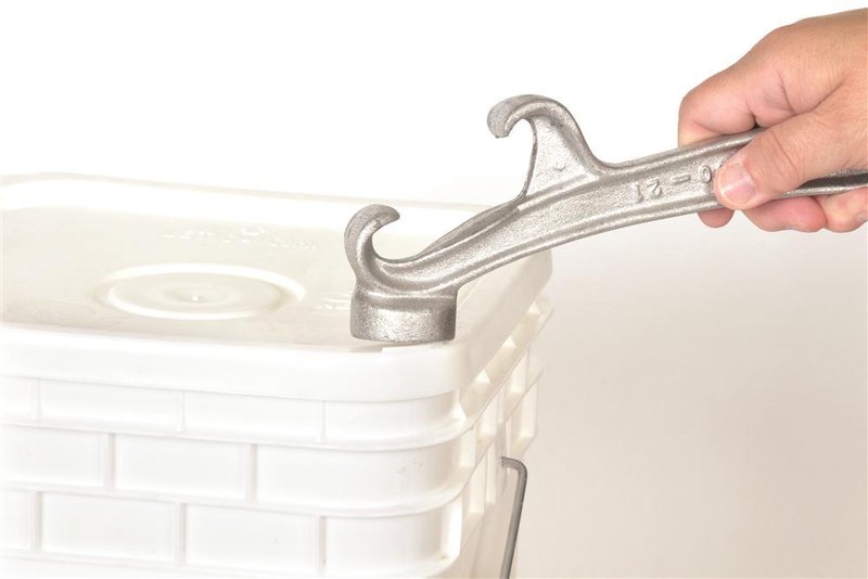 Handcrafted metal tool with hooked end lifting lid on a plastic bucket, designed for Farm, Garden & Tool, Kitchen & Food, and Homesteading collections.
