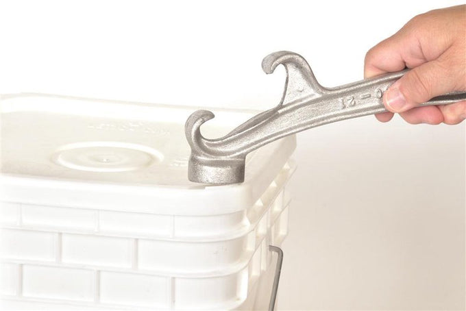 Handcrafted metal tool with hooked end lifting lid on a plastic bucket, designed for Farm, Garden & Tool, Kitchen & Food, and Homesteading collections.