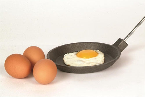 Cast iron skillet with long metal handle cooking a fried egg, shown with three brown eggs nearby, featured in Farm, Garden & Tool, Camping, Best Sellers, and Promo Eligible collections.