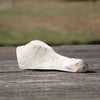 Natural split deer antler dog chew resting on weathered wood, highlighting its durable, splinter-free texture, perfect for pet supplies in USA Made and Best Sellers collections.
