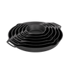 Stacked cast iron skillets with two side handles in varying sizes, designed for durable cooking in kitchen, camping, and farm settings, featured in cookware and cast iron collections.