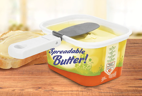Foldable attachable butter knife with a wide paddle-style blade clipped onto a butter tub, designed for easy spreading and included in Kitchen & Food, Kitchen Gadgets, and Best Sellers collections.