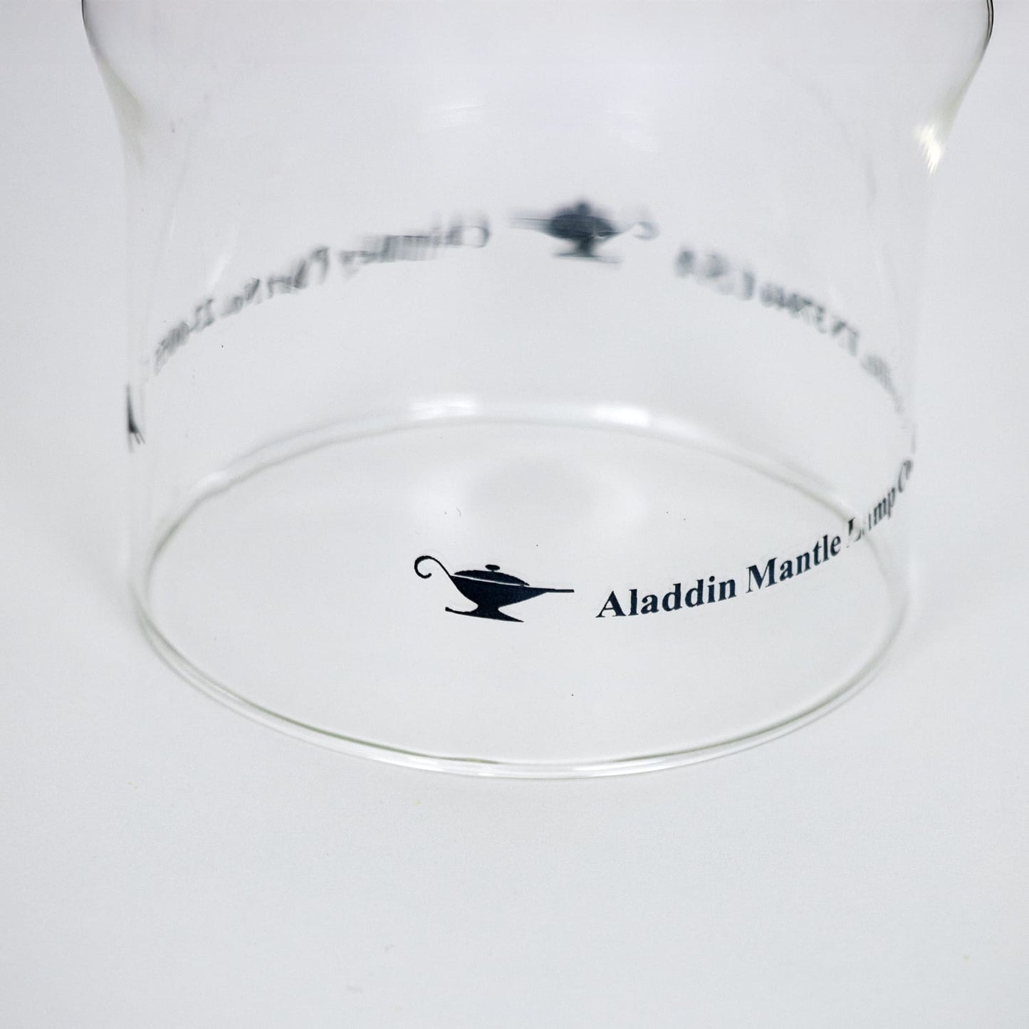 Clear glass chimney with Aladdin Mantle logo printed on the side, designed for use with lamps, lighting parts, chimneys, and best seller collections.