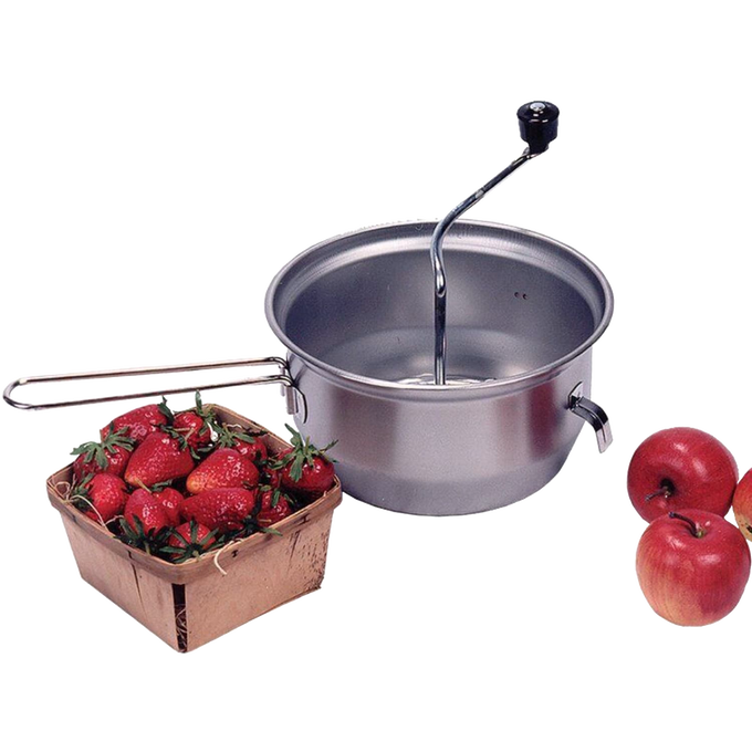 Stainless steel food mill with hand crank and hooks to secure it on bowls, shown alongside fresh strawberries in a wooden basket and red apples, for farm, garden, and kitchen use.