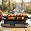 Handcrafted cast iron grill with slide-out ash drawer and removable grate, cooking ribs and vegetables over open flames outdoors, ideal for Farm, Garden & Tool, Camping, and Cookware collections.