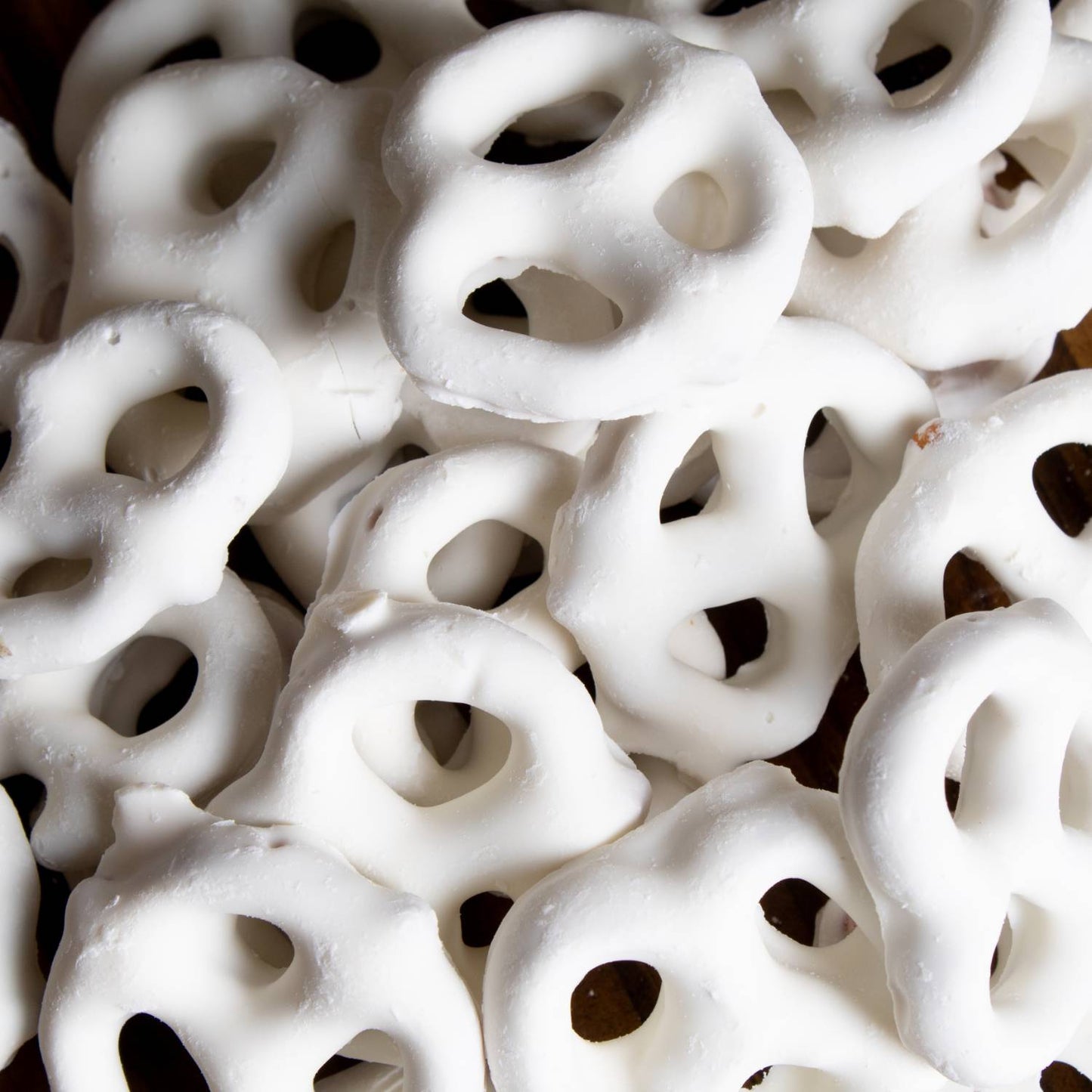 Close-up of handcrafted mini pretzels generously coated in creamy white chocolate, made in USA, a tasty snack from Kitchen & Food, Snacks and Sweets, Candy, Best Sellers, Promo Eligible collections.