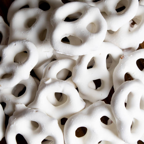 Close-up of handcrafted mini pretzels generously coated in creamy white chocolate, made in USA, a tasty snack from Kitchen & Food, Snacks and Sweets, Candy, Best Sellers, Promo Eligible collections.