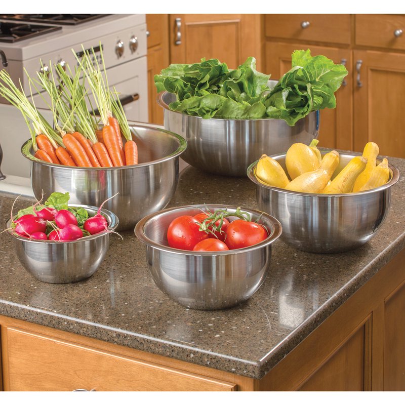 Set of handcrafted stainless steel mixing bowls with weighted bases and wide lips holding fresh vegetables, ideal for Kitchen & Food, Cookware, Baking Supplies, and Best Sellers collections.