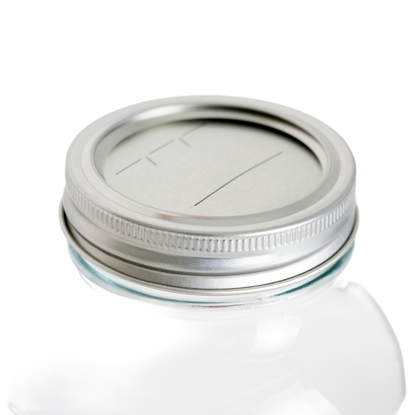 Silver metal lid and band with BPA-free sealing compound fitted on a regular-mouth glass jar, ideal for Kitchen & Food, Food Preservation, and Canning collections.