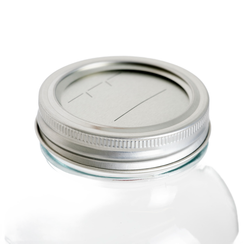 Silver metal lid and band with BPA-free sealing compound fitted on a regular-mouth glass jar, ideal for Kitchen & Food, Food Preservation, and Canning collections.