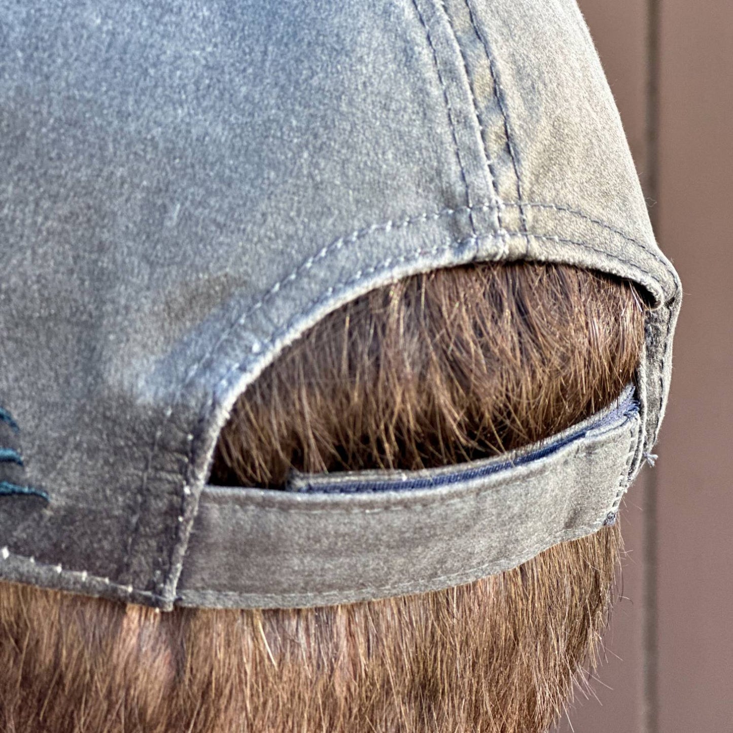 Close-up of the back of a washed cotton adjustable cap with hook and loop closure, featuring a vintage-style weathered look, ideal for Health & Wellness, Clothing and Accessories, Best Sellers, and Promo Eligible collections.