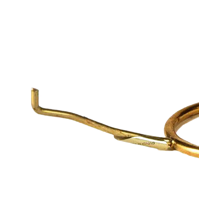 Close-up view of a solid brass tripod holder arm designed to support lamp shades, suitable for lamps & lighting, parts and accessories, shade rings and holders, best sellers, and promo eligible collections.