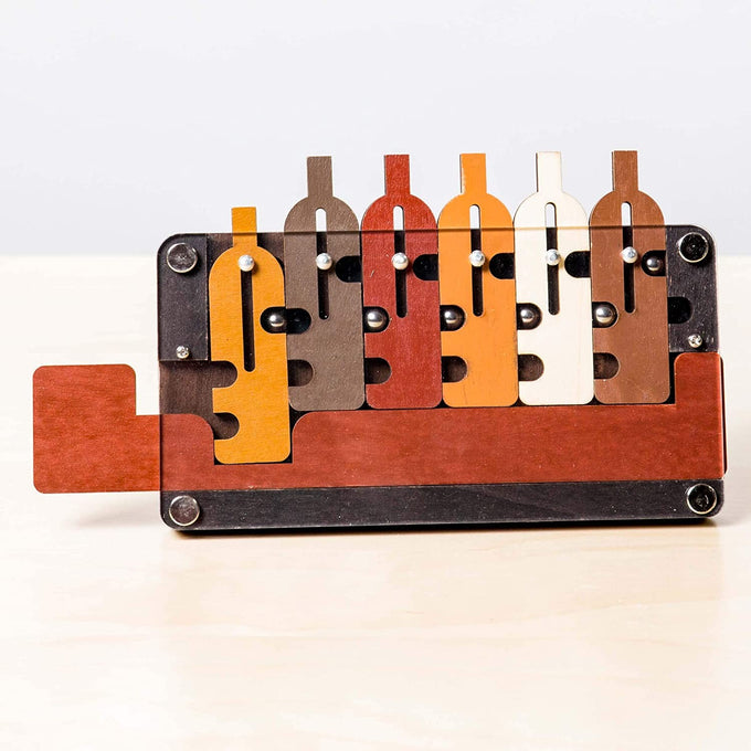 Handcrafted wooden brainteaser puzzle featuring six interlocking bottles in earth tones on a tray, designed to challenge problem solvers; part of Toys, Books & Games and Best Sellers collections.