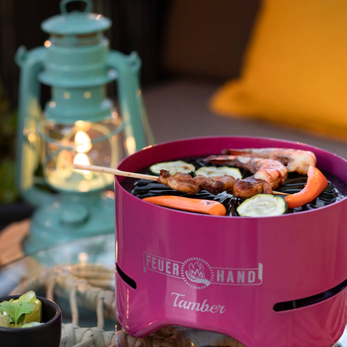 Handcrafted pink tabletop charcoal grill cooking skewers with shrimp, vegetables, and meat, set beside a vintage turquoise lantern, ideal for Farm, Garden & Tool, Camping, and Grilling collections.