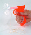 Handcrafted bright orange plastic fly shooter with spring-loaded mechanism and clear suction cup tip, shown in use, ideal for Farm, Garden & Tool and Garden Accessories collections.