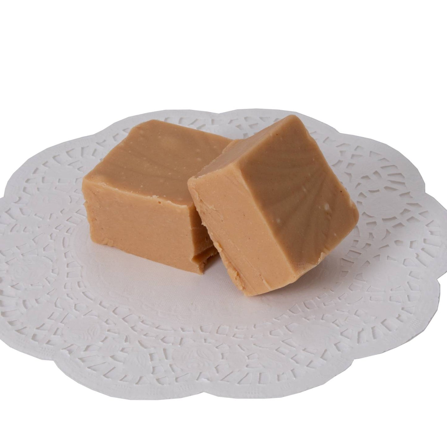 Two pieces of creamy handcrafted fudge resting on a white paper doily, showcasing rich, smooth texture, ideal for Kitchen & Food, Snacks and Sweets, and Best Sellers collections.