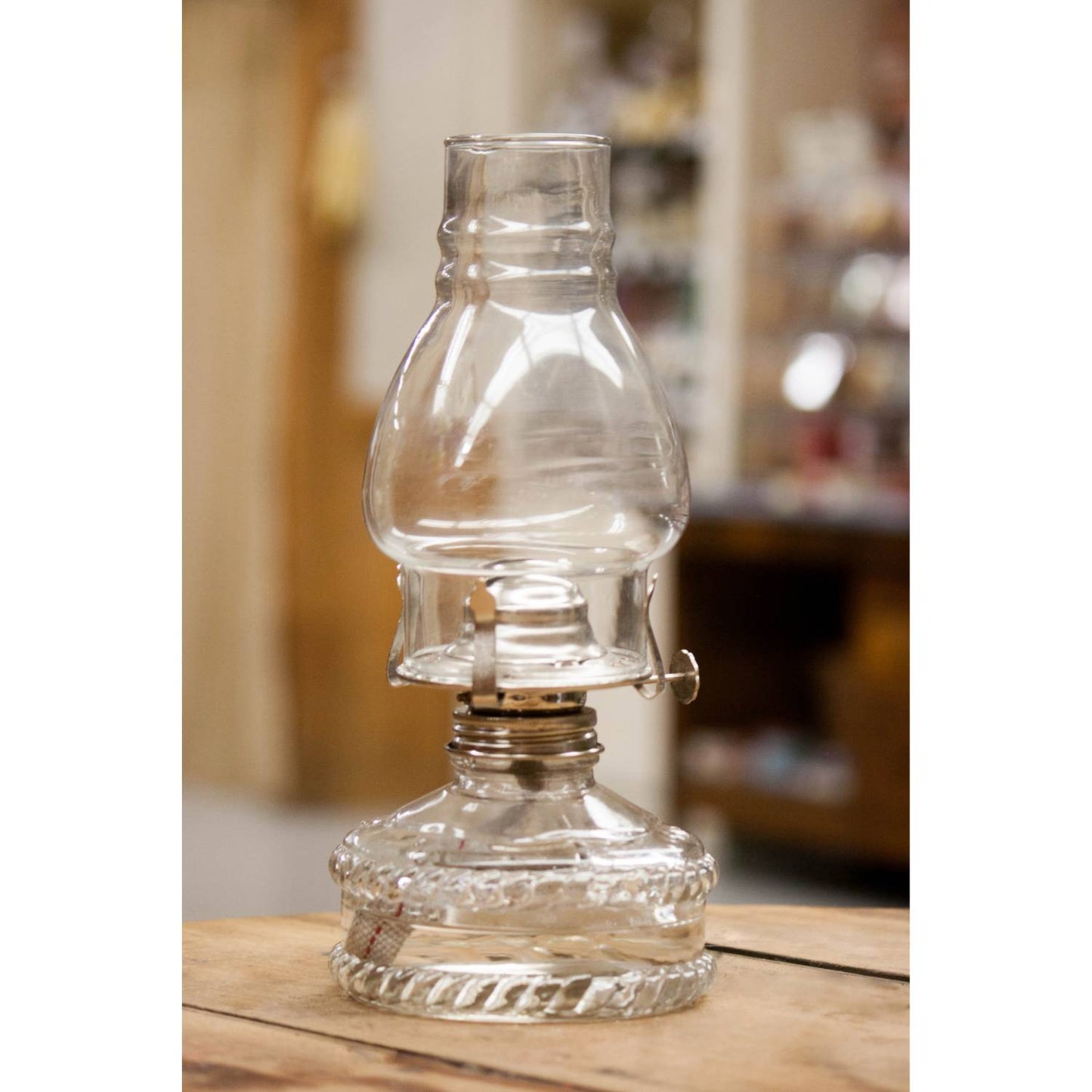 Handcrafted clear glass oil lamp with a glass chimney and decorative base, offering bright, reliable light, featured in Farm, Garden & Tool, Lamps & Lighting, and Emergency Supplies collections.