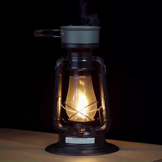 Handcrafted black powder-coated steel Rayo Lantern Cooker with bright adjustable flame, heating a pot on top, ideal for Farm, Garden & Tool, Camping, and Emergency Supplies collections.