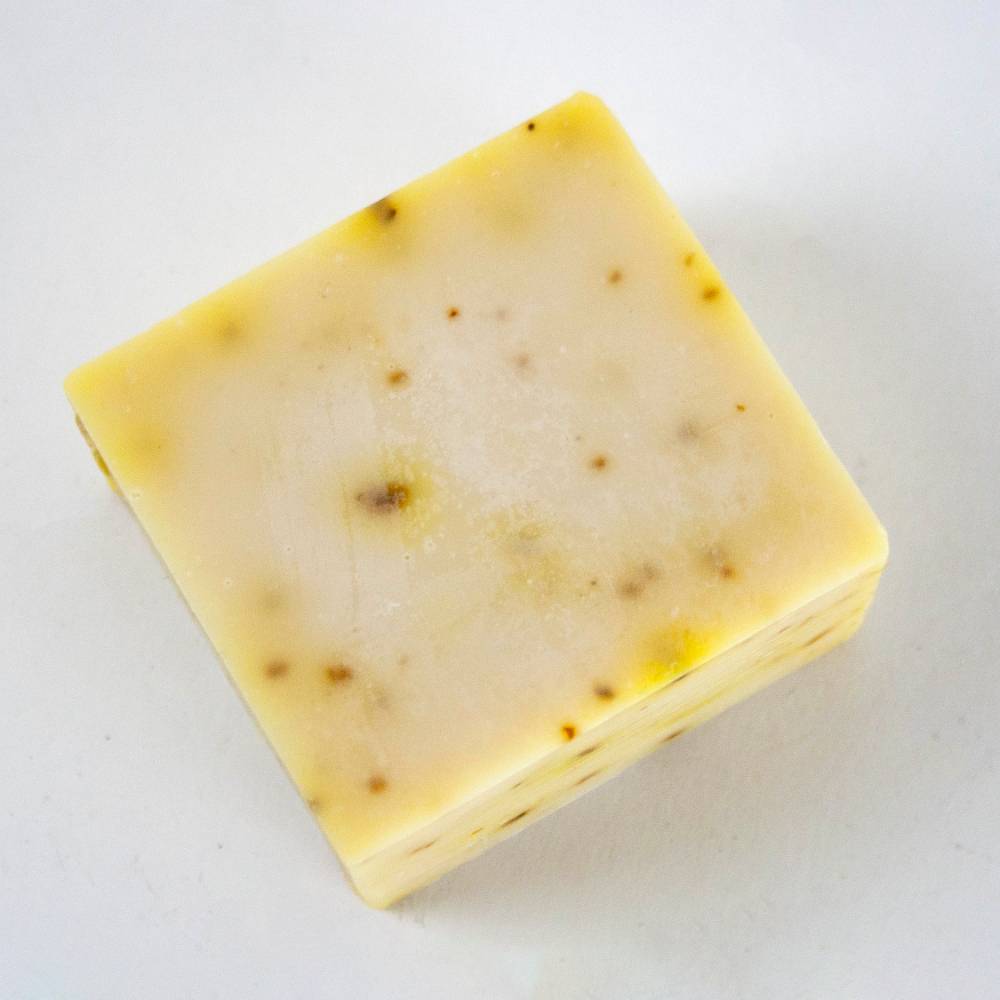 Handcrafted hypoallergenic bar soap with a creamy light yellow tone and natural specks, made in USA, perfect for Health & Wellness and Grooming and Personal Hygiene collections.