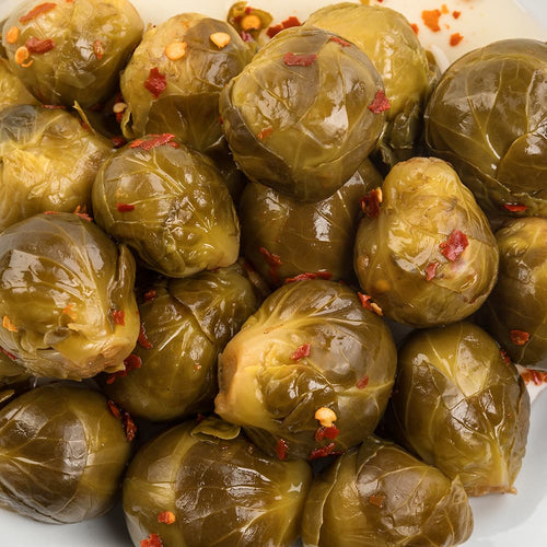 Close-up of pickled Brussels sprouts with red pepper flakes, showcasing their tangy, handcrafted preparation, ideal for Kitchen & Food, Food, Pantry, USA Made, Best Sellers, and Promo Eligible collections.