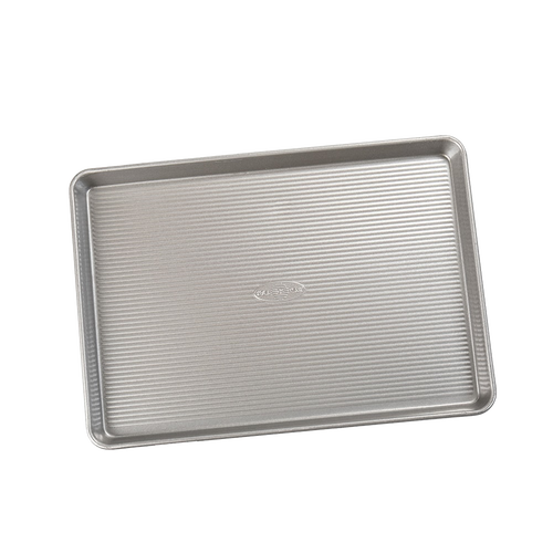 Durable aluminized steel half sheet pan with ribbed surface for even heat distribution, ideal for baking cakes, jelly rolls, and roasting vegetables, part of Kitchen & Food and USA Made collections.