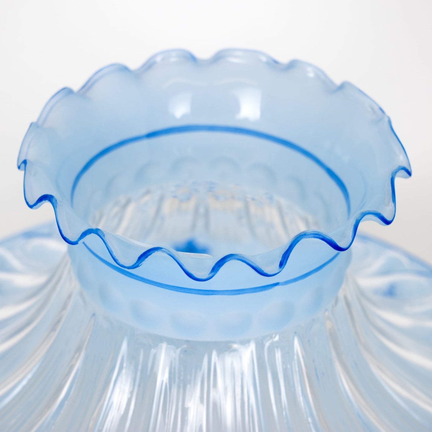 Close-up of a handcrafted blue glass oil lamp shade with ruffled edges, designed to soften light, featured in Lamps & Lighting, Parts and Accessories, Lamp Shades, and Best Sellers collections.