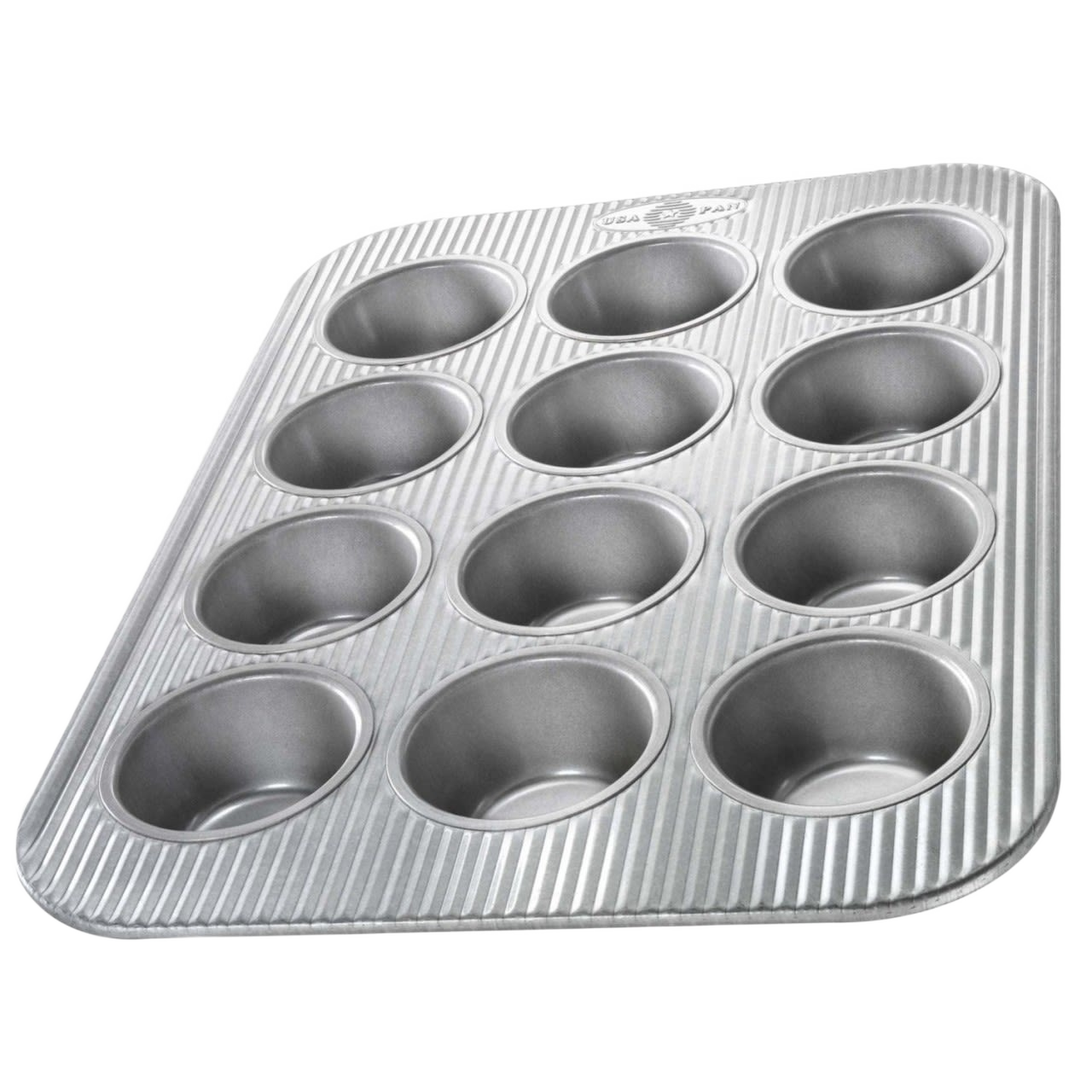 Durable non-stick muffin pan with 12 cups featuring a fluted design for even heating, handcrafted in the USA, ideal for baking, Kitchen & Food, and Cookware collections.