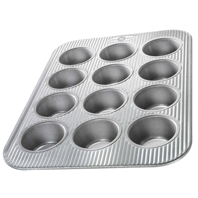 Durable non-stick muffin pan with 12 cups featuring a fluted design for even heating, handcrafted in the USA, ideal for baking, Kitchen & Food, and Cookware collections.