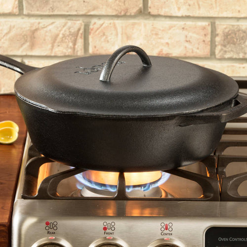 Pre-seasoned deep cast iron chicken fryer with lid featuring self-basting nubs, sitting on a gas stovetop, ideal for Kitchen & Food, Cookware, Cast Iron, and Best Sellers collections.