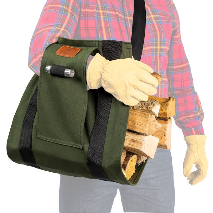 Heavy-duty green canvas firewood carrier with adjustable black straps and built-in flashlight holder, ergonomically designed to hold large loads securely under the arm, ideal for Farm, Garden & Tool, Wood Cutting and Hauling, USA Made, Hearth Accessories, and Best Sellers collections.