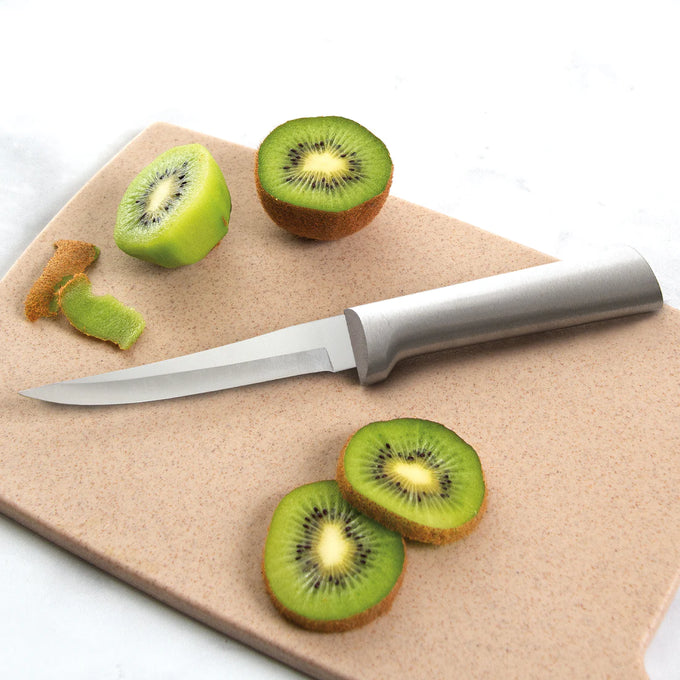 Handcrafted Rada Super Parer with high carbon surgical steel blade and solid aluminum handle slicing fresh kiwi on a cutting board, ideal for kitchen knives and food prep collections.