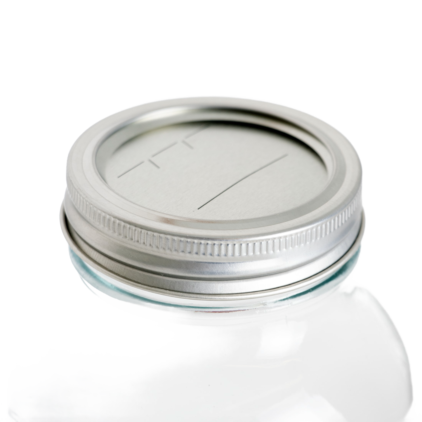 Silver metal regular-mouth canning lid and matching band with BPA-free sealing compound, shown on a clear glass jar, ideal for Kitchen & Food, Food Preservation, and Canning collections.