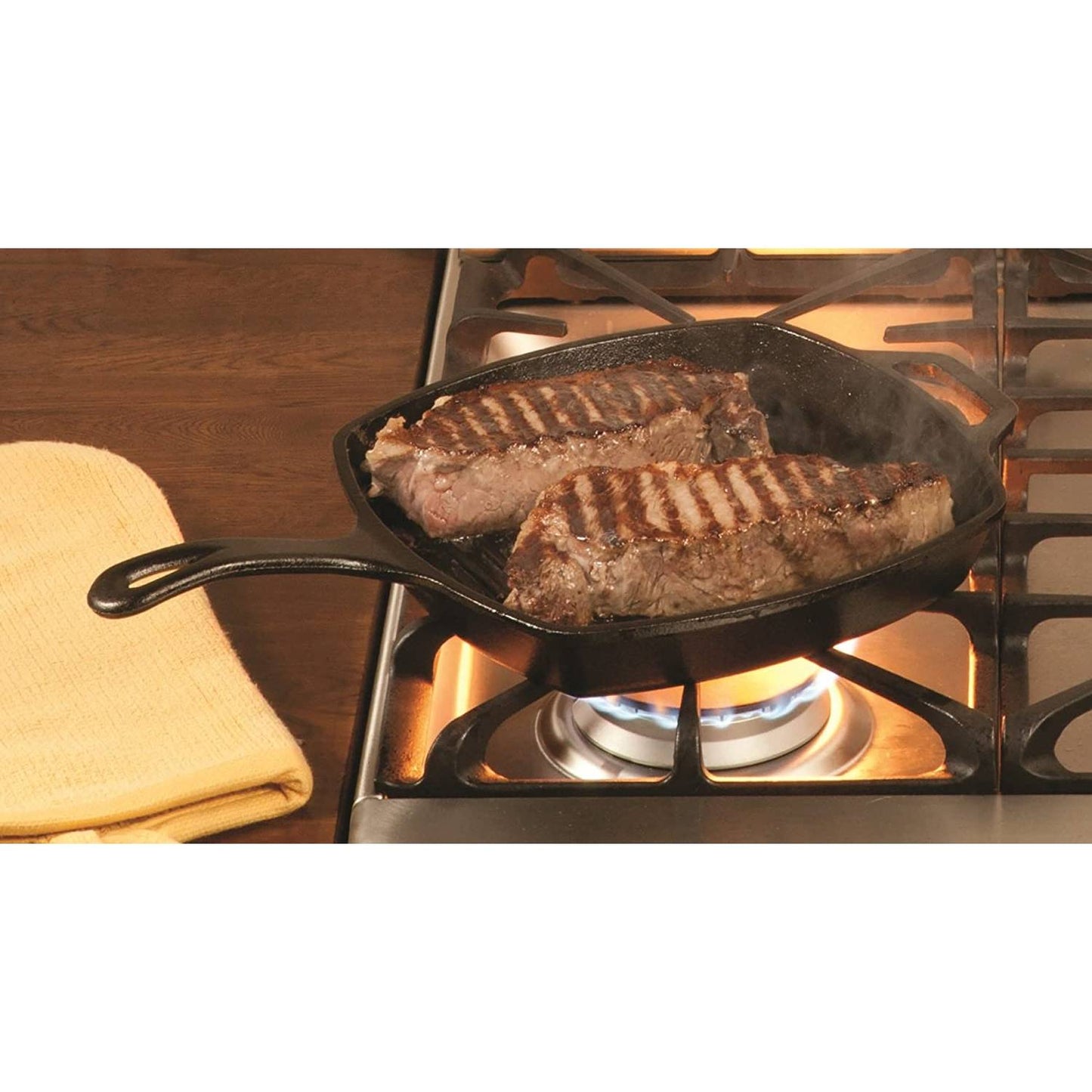 Cast iron square grill pan searing two steaks on a gas stove burner, showcasing heat retention and even cooking, suitable for Kitchen & Food, Cookware, and Cast Iron collections.