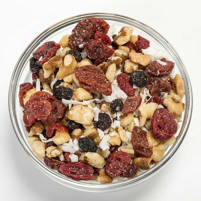 Clear glass bowl filled with a protein-rich snack mix of roasted black walnuts, dried cherries, cranberries, blueberries, and shredded coconut, perfect for Kitchen & Food, Snacks and Sweets, Pantry, USA Made, and Best Sellers collections.