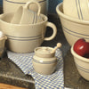 Handcrafted Heritage Blue Stripe stoneware honey pot with lid and wooden dipper, set on blue checkered cloth alongside matching rustic stoneware bowls and mugs, Kitchen & Food, Storage and Serving, USA Made, Best Sellers, Promo Eligible collections.