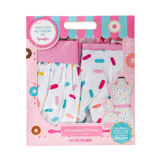 Child-sized chef accessory set with a white apron, oven mitt, and hat decorated with colorful sprinkle patterns, packaged in a playful pink box for Kitchen & Food, Children's Toys, and Arts and Crafts collections.
