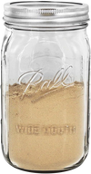 Clear wide-mouth quart jar made in the USA with metal lid, filled with ground spice, suitable for kitchen storage, food preservation, canning, and craft uses.