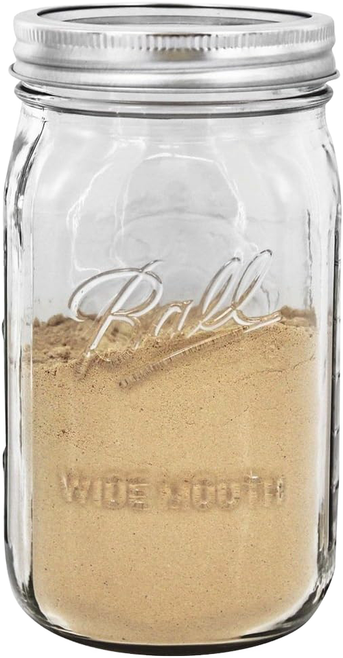 Clear wide-mouth quart jar made in the USA with metal lid, filled with ground spice, suitable for kitchen storage, food preservation, canning, and craft uses.