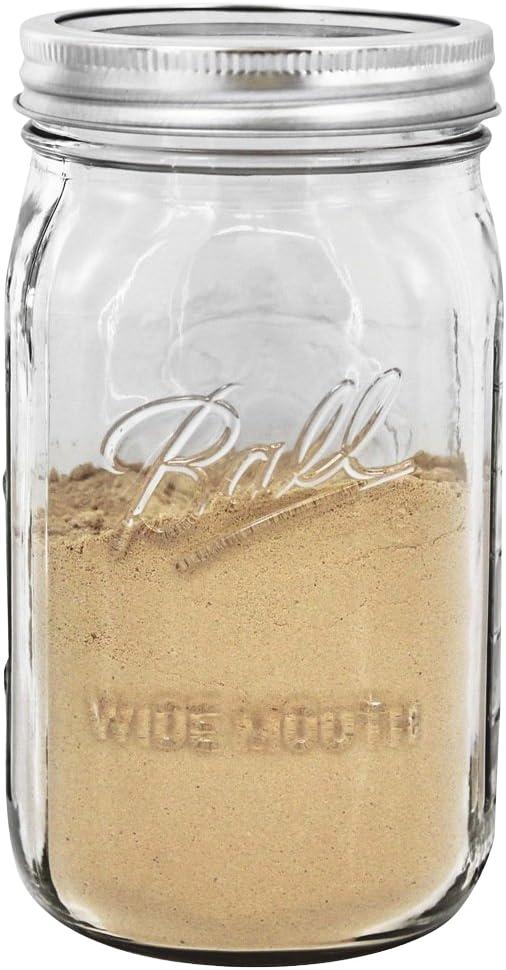 Clear wide-mouth quart jar made in the USA with metal lid, filled with ground spice, suitable for kitchen storage, food preservation, canning, and craft uses.
