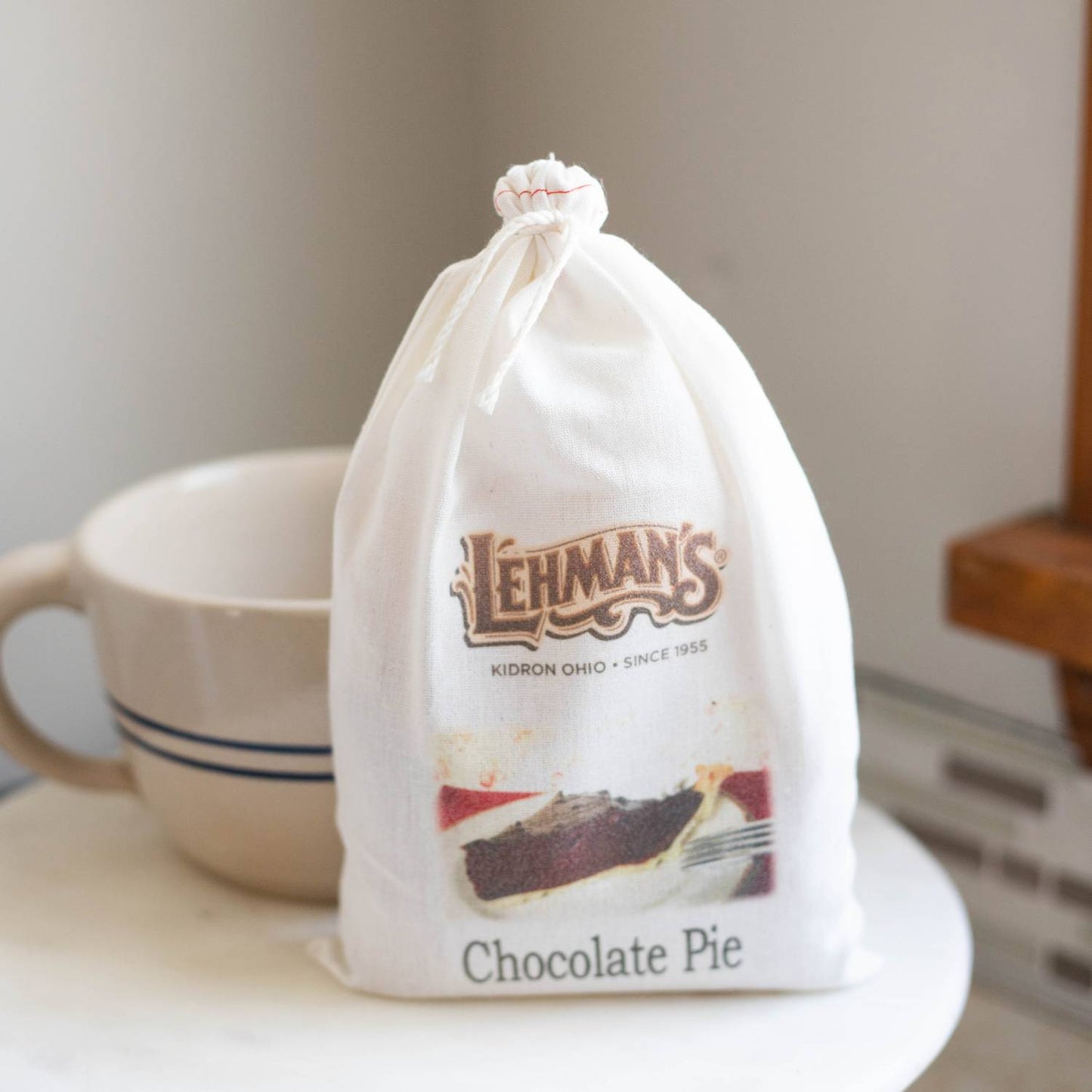 Soft white drawstring bag with Lehman’s logo and image of chocolate pie slice, handcrafted Amish style, suited for Kitchen & Food, Snacks and Sweets, and Best Sellers collections.