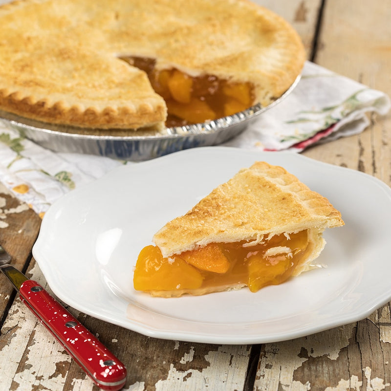 Slice of handcrafted peach pie with golden crust served on white plate, featuring juicy peach filling, made in USA, perfect for Kitchen & Food and Snacks and Sweets collections.