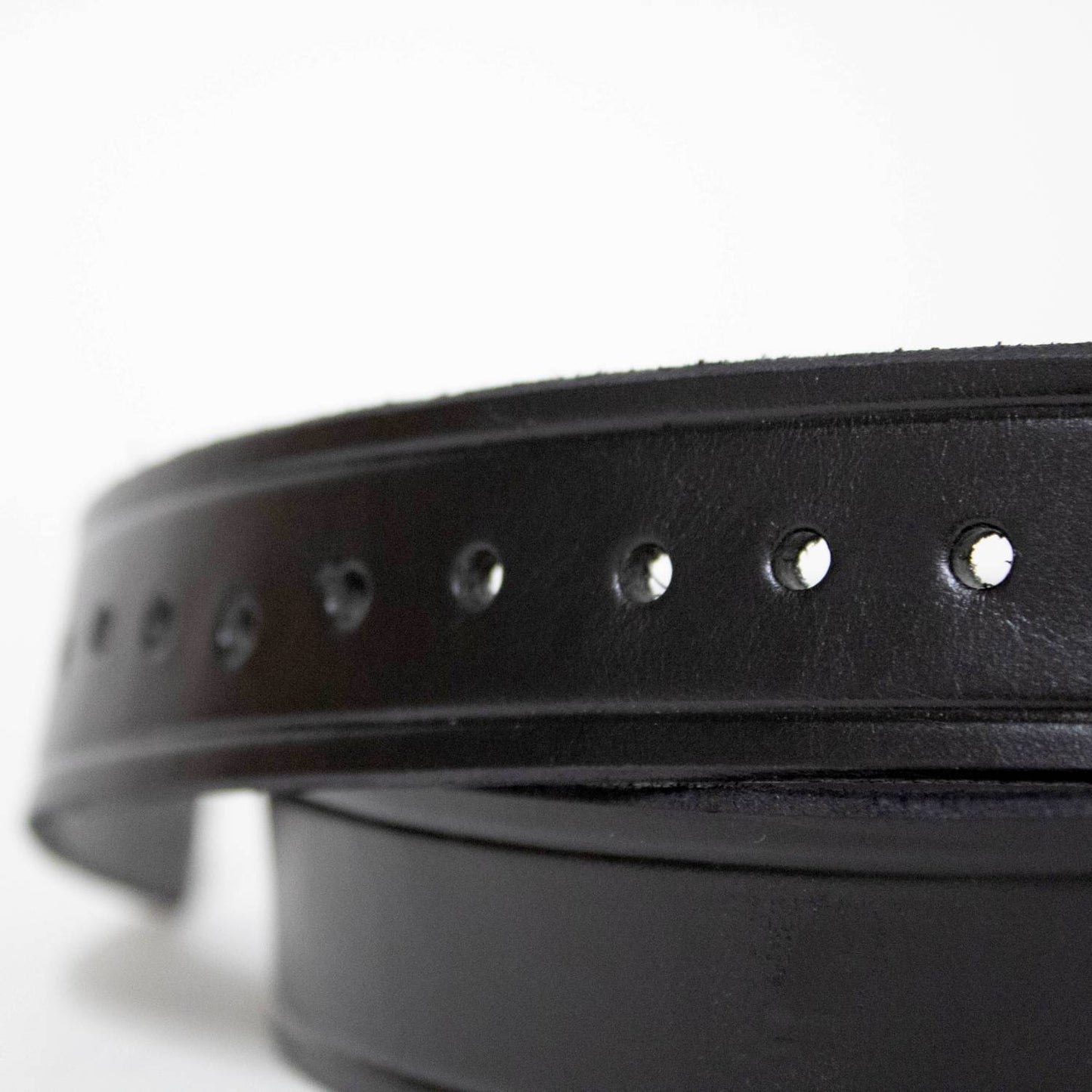 Close-up of a handcrafted black genuine cowhide leather belt with evenly spaced adjustment holes and polished chrome snaps, Amish made in USA, featured in Health & Wellness and Clothing and Accessories collections.