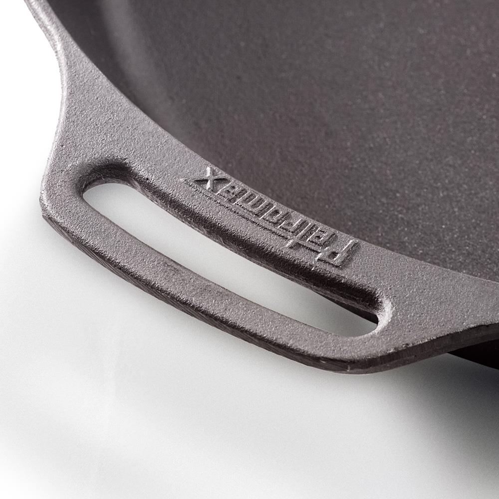 Close-up of a sturdy cast iron skillet helper handle with embossed branding, highlighting durable craftsmanship for Farm, Garden & Tool, Kitchen & Food, Camping, Cookware, Cast Iron, Best Sellers, and Promo Eligible collections.