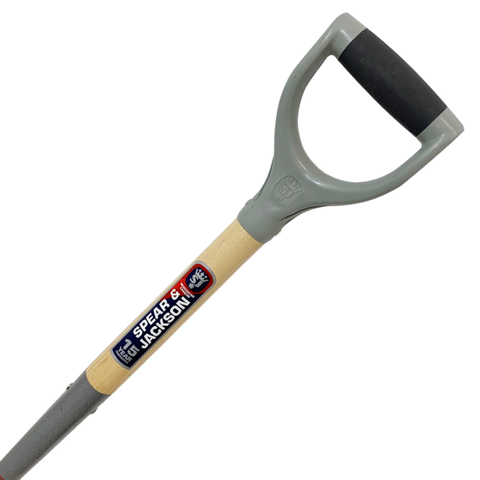 Close-up of a digging fork handle with a D-grip made of gray molded material and black rubber overlay, featuring a natural wood shaft labeled for Farm, Garden & Tool and Digging and Cultivating collections.
