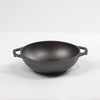 Handcrafted cast iron mini wok with flat bottom and sloped sides, featuring loop handles, pre-seasoned for nonstick cooking and compatible with all stovetops, part of USA Made cookware collections.