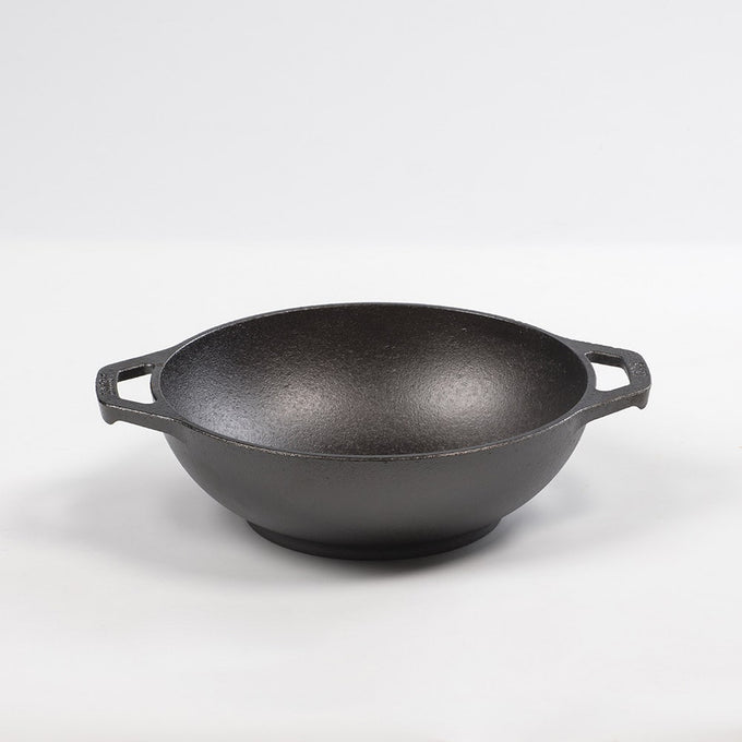 Handcrafted cast iron mini wok with flat bottom and sloped sides, featuring loop handles, pre-seasoned for nonstick cooking and compatible with all stovetops, part of USA Made cookware collections.