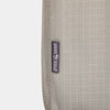 Close-up of a beige padded nylon transport bag with reinforced stitching and a small fabric label, designed for safely carrying lanterns in camping and emergency supplies collections.