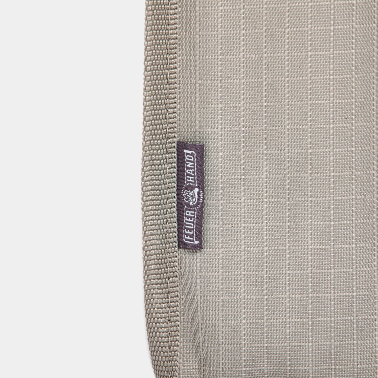 Close-up of a beige padded nylon transport bag with reinforced stitching and a small fabric label, designed for safely carrying lanterns in camping and emergency supplies collections.